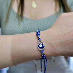 The Evil Eye charm has been used for centuries as a talisman for protection against misfortunes and malicious intent. It is thought to bring the wearer good luck.This adjustable sliding knot bracelet comes in an assortment of evil eye styles in a gold finish. Adjustable Evil Eye Spiritual Jewelry, Adjustable Spiritual Evil Eye Jewelry, Spiritual Jewelry With Sliding Knot For Festivals, Adjustable Teardrop Bracelet For Gifts, Adjustable Symbolic Evil Eye Jewelry, Adjustable Bohemian Evil Eye Bracelet For Good Luck, Bohemian Evil Eye Bracelet For Good Luck, Adjustable Jewelry With Sliding Knot For Blessing, Bohemian Teardrop Bracelets For Gifts