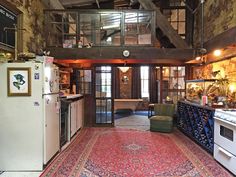 the kitchen is very large and has an old fashioned rug on the floor in front of it