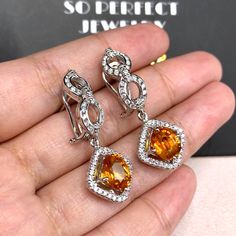 STUNNING 6.17 Total Carats, VIVID orange sapphires and 1.12 carats of F/VS, natural diamonds, set in handmade 12 grams, 18K solid white gold dangling, earrings, with secured omega, latch back. Easy to wear, and comfortable. With natural sapphires and sparkling diamonds, set in one of a kind, 18K Solid white gold, dangling earrings. ONE OF A KIND HANDCRAFTED EARRINGS. IN CASE OF RETURN FOR US BUYERS. BUYERS MAY SEND THE ITEMS BACK TO OUR US-BASED OFFICE IN SALT LAKE CITY, UTAH Our jewelry are spe Orange Earrings For Anniversary In Fine Jewelry Style, Orange Drop Earrings For Formal Occasions, Orange Fine Jewelry With Matching Earrings, Formal Yellow Sapphire Jewelry, Fine Jewelry With Orange Cubic Zirconia, Fine Jewelry In Orange Sterling Silver, Luxury Yellow Sapphire Women's Jewelry, Orange Fine Jewelry With Polished Finish, Luxury Orange Drop Earrings