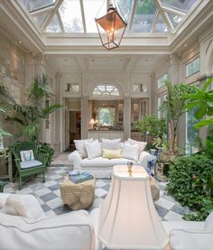 a living room filled with lots of white furniture