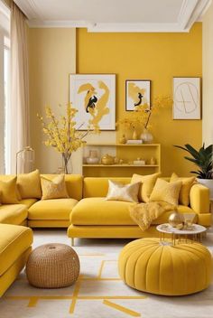 a living room with yellow furniture and pictures on the wall above it's couches