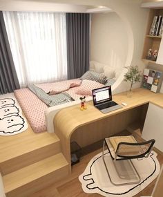 a laptop computer sitting on top of a desk next to a bed in a room