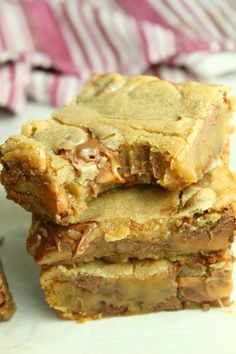 three pieces of chocolate peanut butter bars stacked on top of each other