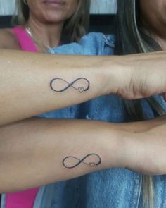 two women with matching tattoos on their arms