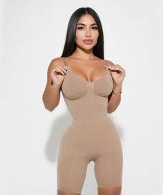 The Sculpting Bodysuit Mid Thigh offers a slimming and contouring fit with mid-thigh length coverage. Its high-stretch shapewear fabric customizes for a comfortable fit, providing a smoother silhouette. Enjoy the slimming benefits of the compression technology for a more defined look. Beige Smoothing Sculpting Bodysuit, Beige Sculpting Smoothing Bodysuit, Fitted Beige Shapewear Bodysuit, Beige Fitted Shapewear Bodysuit, Fitted Beige Seamless Bodysuit, Fitted Seamless Beige Bodysuit, Fitted Beige Bodysuit For Loungewear, Fitted Shapewear With Built-in Bra For Loungewear, Fitted Beige Shapewear For Loungewear