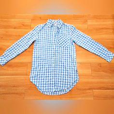 Preppy Longsleeve Shirt With Light Blue Checkered Patterns. Blue Tops With Roll-up Sleeves For Daywear, Blue Shirt With Rolled Sleeves For Daywear, Blue Casual Tops With Roll-up Sleeves, Casual Blue Tops With Roll-up Sleeves, Blue Long Sleeve Top With Roll-up Sleeves, Blue Long Sleeve Shirt With Rolled Sleeves, Blue Tops With Rolled Sleeves For Day Out, Blue Shirt With Rolled Sleeves For Spring, Blue Cotton Tops With Roll-up Sleeves