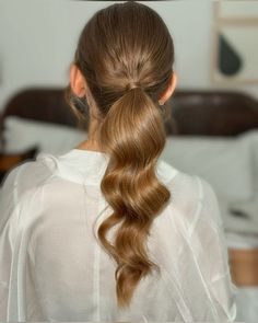 a woman with long hair in a ponytail