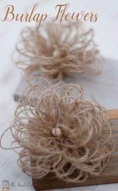 there are some burlap flowers on top of a piece of wood with the words burlap flowers above it