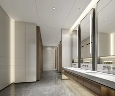 an empty bathroom with sinks and mirrors in the wall, along with lights on either side