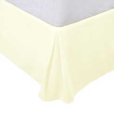 a white bed skirt on top of a bed