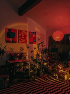 a living room filled with lots of furniture next to a window covered in red lights