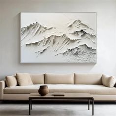 a living room with a large painting on the wall and a coffee table in front of it