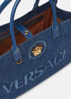 Crafted from denim canvas with leather top handles, this shopper bag is adorned with a Medusa plaque and raised logo lettering. The roomy interior has a large zipped pocket and protector strap, and the D-ring provides an optional attachment for a keyring or charm. Luxury Tote Bags, Denim Bags, Versace Handbags, Suit Bag, Denim Tote Bags, Versace Bags, Denim Tote, Chic Bags, Cute Purses