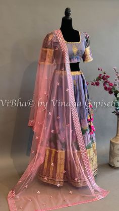 Indulge in the luxurious beauty of our Purple Floral Kanchi Silk Lehenga. With its intricately embroidered borders and delicate purple floral design, this lehenga is sure to make you the center of attention at any special occasion. Paired with a Kanchi Kalamkari Dupatta, experience an elegant fusion of traditional and modern styles. Fitted Floral Embroidered Tissue Silk Sharara, Brocade Sets With Floral Embroidery For Reception, Transitional Season Festive Lehenga With Floral Embroidery, Tissue Silk Choli With Floral Embroidery For Reception, Transitional Bollywood Lehenga With Floral Embroidery, Transitional Festive Lehenga With Floral Embroidery, Fitted Lehenga With Floral Embroidery In Chanderi, Fitted Chanderi Lehenga With Floral Embroidery, Fitted Floral Embroidered Tissue Silk Sets