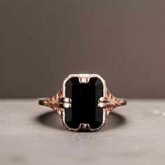 a black stone ring sitting on top of a table