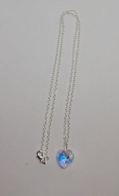 "This beautiful Swarovski Crystal Clear AB heart-shaped pendant hangs on a sterling silver chain. **AB (Aurora Borealis) is a shimmering, iridescent rainbow effect that creates an even greater sparkling quality to the base color and reflects varying colors depending on the angle of light. Pick you chain:16\" Cable, 18\" Cable, 20\" Cable, or 24\" Cable Pendant Size: 14x14mm Necklace is packaged in a white cotton-filled gift box. **Matching Earrings Available** https://www.etsy.com/SunshineJazzyJ Silver Heart Cut Crystal Necklace For Valentine's Day, Silver Heart-shaped Crystal Necklace With Heart Charm, Silver Heart Crystal Necklace With Heart Charm, Valentine's Day Heart Pendant Crystal Necklace In Sterling Silver, Valentine's Day Sterling Silver Crystal Heart Pendant Necklace, Valentine's Day Sterling Silver Heart Pendant Crystal Necklace, Silver Crystal Heart Charm Necklaces, Silver Crystal Necklace With Heart Charm Pendant, Silver Sterling Silver Heart Crystal Necklaces