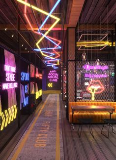 the inside of a building with neon lights hanging from it's ceiling and benches on either side