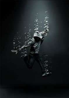 a man is jumping in the air with his arms spread out and water splashing around him