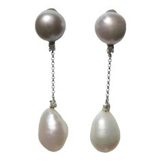 A beautiful pair of gray and white freshwater pearl and diamond dangle earrings set in 18-karat white gold, circa late-20th century, Made in Italy. Each earring has a grey freshwater pearl at top, diamond below it, 18-karat white gold link chain, followed by another diamond and a white freshwater pearl. Pearls have a beautiful luster. Earrings include 18-karat gold posts and backs. Each earring is marked '585', a European jewelry mark, and '750' for 18-karat gold. Dimensions: 1.88" Long.  Turquo Silver Diamond Pearl Drop Earrings For Evening, Silver Drop Pearl Earrings With Diamonds, Silver Tahitian Pearl Earrings For Wedding, Silver Diamond Dangle Earrings With Pearl Drop, European Jewelry, Metal Drop, Gold Link Chain, Gold Dangle Earrings, Diamond Dangle Earrings