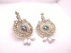 * This astonishing pair earing is a classical ornament, embellished with various elements and fine work. * The Bohemian inspired earrings feature craved motifs, Feruza stones and tinny dangling white beads. * The huge sized earrings would complete your stylish look and would add a pinch of ethnic touch to your modish look. * We assure you the High-Quality Product with On Time Delivery * Traditional Dangle Pearl Earrings, Traditional White Pearl Earrings, Traditional White Pearl Pierced Earrings, Traditional Pierced Pearl Drop Earrings, Pierced Drop Bridal Earrings For Festive Occasions, Festive Chandbali Pierced Earrings, Traditional Pierced Earrings For Festive Occasions, Handmade Pearl Earrings For Festivals, White Bohemian Earrings With Intricate Design