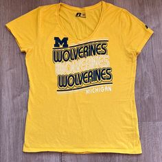 University Of Michigan Wolverines Game Day Women’s T-Shirt. Size: Medium (8-10) University Of Michigan Wolverines Game Day Apparel. Show Your School Spirit Or Support Your Friends Or Family Member On A University Team. Perfect For Game Day Or Any Day! Yellow. Navy Blue And White Wolverines Logo. V-Neck. Short Sleeves. Material: 100% Cotton. Machine Wash. Measurements: Armpit To Armpit- 18” Waist- 17” Hem- 18.5” Length- 24.5” Nwot. Never Worn. Yellow Team Spirit T-shirt With Graphic Print, Yellow Sports T-shirt With Logo Print, Sporty Yellow T-shirt For Fan Merchandise, Yellow Sporty T-shirt With Letter Print, Yellow Tops With Logo Print, Casual Yellow T-shirt With Team Name, Sporty Yellow T-shirt With Text Print, Sporty Yellow T-shirt With Letter Print, Yellow Tops With Screen Print For Sports