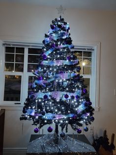 6ft, Black faux Christmas tree with cool white lights, wide blue and purple glitter tulle ribbon, blue, purple and silver ornaments, and silver glitter star topper. Galaxy Theme Christmas Tree, Purple And Blue Christmas Decorations, Blue And Black Christmas Decor, Galaxy Christmas Tree, Grey Christmas Decor, Galaxy Christmas, Faux Christmas Tree