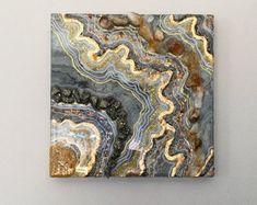 an abstract painting on a wall with rocks and stones in the center, as if it were marbled