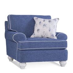 a blue chair with a pillow on it's back and white trim around the arms