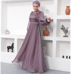 Modest Formal Satin Dress G531 Lilac ATTENTION: This item has a special return policy, different from our regular store policy. See details below. A classy evening dress perfect for formal events! Features a gemmed petal design along the neckline, puffed sleeves, and is made with sleek satin. FEATURES: - Fully lined - Satin fabric with organza overlay - Gemmed petal design along neckline - Puffed sleeves with a small flare at the wrist - Matching satin waistband with glitter along sides FABRIC Satin fabric made from 100% Polyester. Weighs about 2 lbs CARE: Dry clean only Do not machine wash Do not machine dry Do not bleach Made in Turkey SPECIAL RETURN POLICY FOR EVENING GOWNS The following return policy applies on all evening gowns: • Return must be requested within 48 hours of receiving Formal Satin Dress, Thobes Men, Classy Evening Dress, Organza Overlay, Sports Hijab, Small Wall Decor, Eid Party, Islamic Wall Decor, Modest Swimsuits