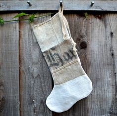 an old stocking hanging on a wooden fence