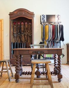 a wooden table sitting inside of a room filled with lots of different types of shoes