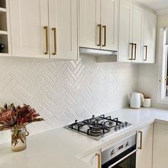 a kitchen with white cabinets and an oven