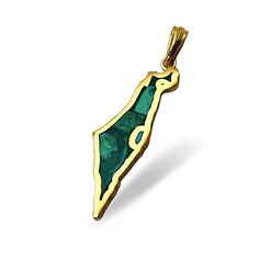 a gold pendant with an emerald green stone in the shape of a map, on a white background