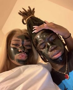 two people with their faces covered in facial masks