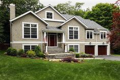 a large house in the middle of a lush green yard