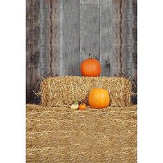 two pumpkins sitting on top of hay bales