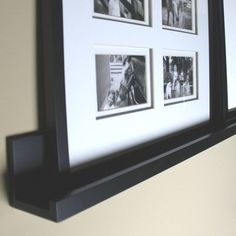 a black and white photo hanging on a wall with four pictures in the frame above it