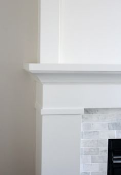 an empty fireplace with white paint on the mantle