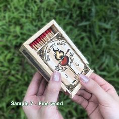 a hand holding a match box with matches in it and the words sample 7 pine wood