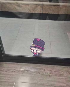 an image of a sticker on the side of a glass door that has a cartoon character wearing a top hat