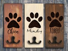 three door hangers with dog paw prints on them and the name chicago, mindy, robert