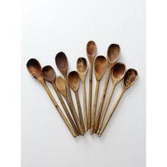 six wooden spoons are lined up in a row