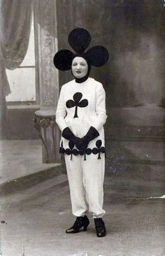 an old black and white photo of a boy in mickey mouse costume