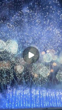 fireworks are lit up in the night sky with blue and white lights on them,