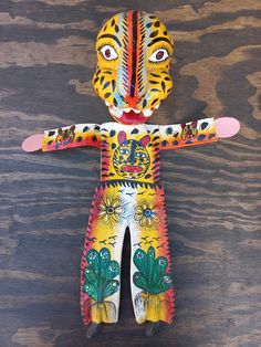 a wooden doll with painted face and body