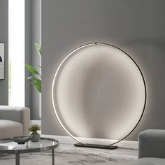 a living room scene with focus on the floor lamp and round table in the center