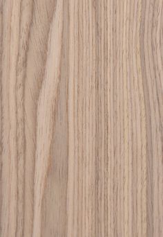 closeup of the grained surface of a wood paneling material that is light brown