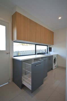 a kitchen with an oven, dishwasher and washing machine in the middle of it