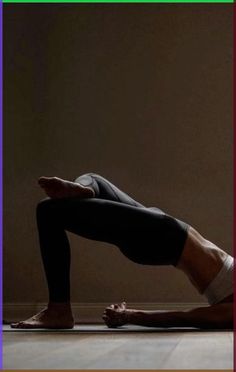 a man is doing a yoga pose on the floor