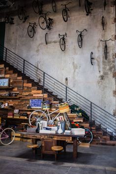 there is a bike that is on the table in front of some stairs and bikes